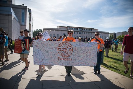 Board members from the Caltech Postdoctoral Association and the Graduate Student Council led marchers from Beckman Lawn to Memorial Park, carrying a banner signed by hundreds of members of the local community to express their support for science.