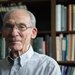 Dr. Stone in front of the bookshelf in his office