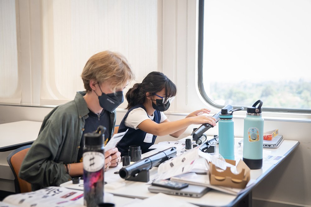 students building telescopes