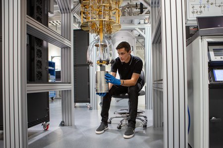 Engineer works on a dilution refrigerator at AWS Center for Quantum Computing.