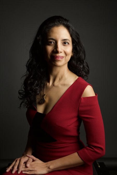 Portrait of a woman with dark hair wearing a red dress