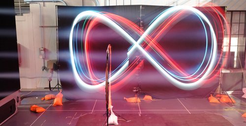 Time-lapse photo shows a drone equipped with Neural-Fly maintaining a figure-eight course amid stiff winds at Caltech's Real Weather Wind Tunnel.