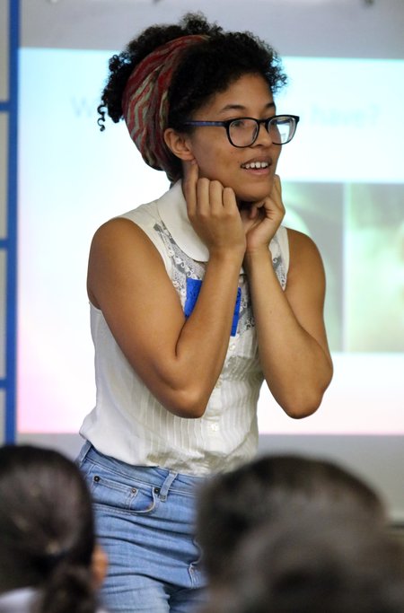 Graduate student Cecelia Sanders explains to a second grade class how genes affect the shape of body parts such as earlobes.