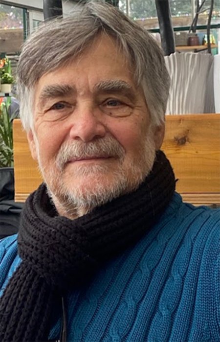 Chas wearing a black scarf.