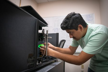 man examines an egg with scientific machinery