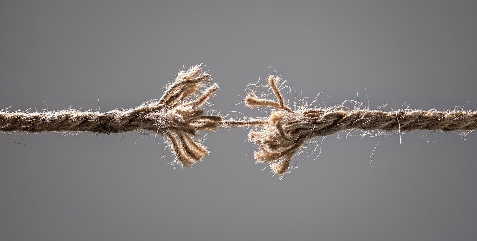 A frayed rope is shown about to be torn in half in the middle.