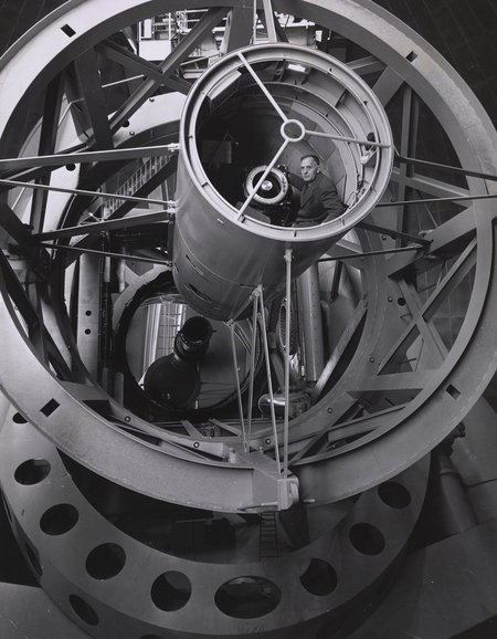 Edwin Hubble inside the prime focus cage at the Hale Telescope