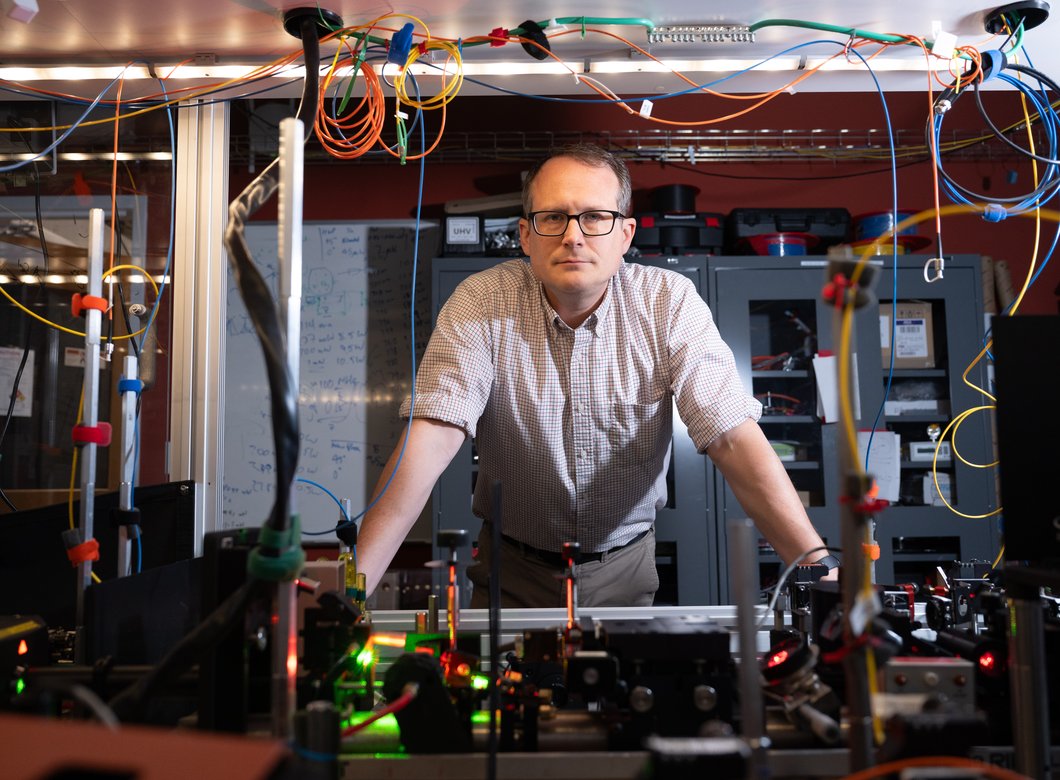 Image of Nick Hutzler leaning on lab equipment