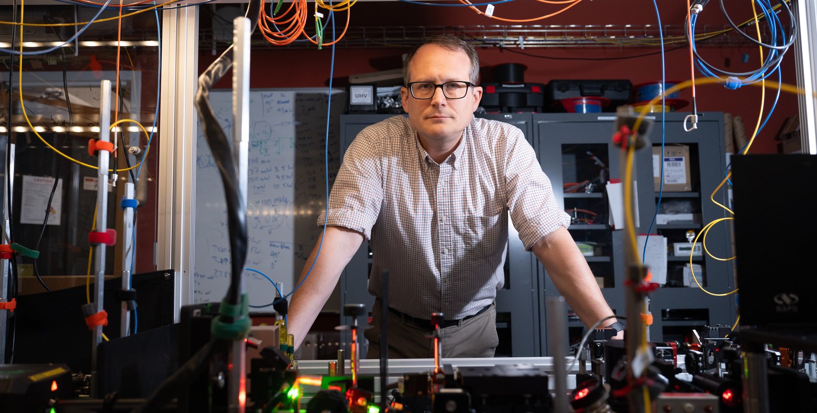 Image of Nick Hutzler leaning on lab equipment