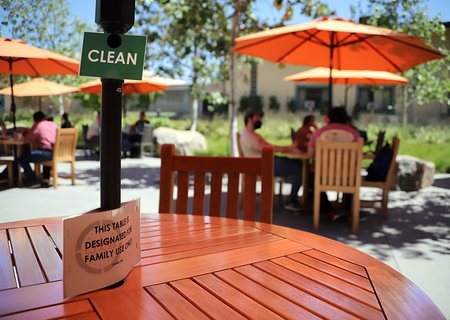 An empty table marked "Clean" outside the red Door Cafe