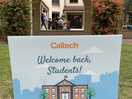 A sign on the lawn welcomes students back to campus.