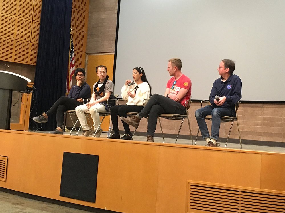 A panel of Caltech-linked astrophysicists talks on the stage at Furnace Creek visitor center auditorium in Death Valley National Park.