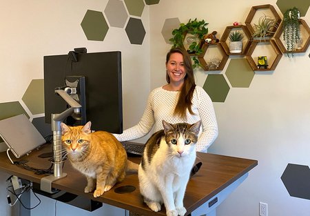 Kirby Nielsen at home with her two cats, Ender and Aslan.