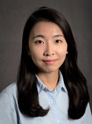 A portrait of Minju Chung. She wears a long-sleeve button-up shirt.