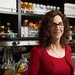 Portrait of Professor Pamela Bjorkman in her biology lab with flasks and pipettes behind her