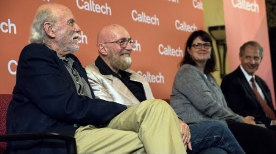 Scientists speaking at a press conference with a Caltech banner in the background.