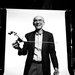 A smiling man holding a small model of a spacecraft