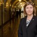 A woman in a black blazer in the hallways of a Caltech building