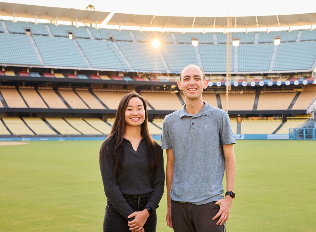 Grace Peng and Ryan Casey stand on the field at Dodger Stadium
