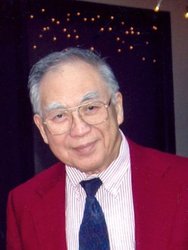 A photo of Theodore Wu. He wears a shirt and tie and blazer.