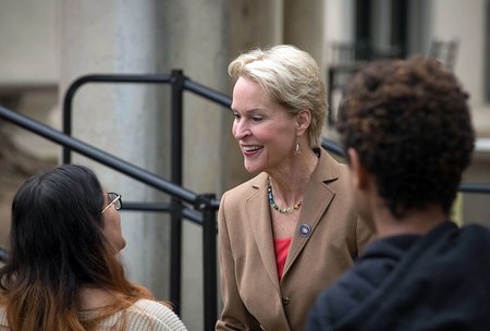 photo of Frances Arnold greeting people at the event