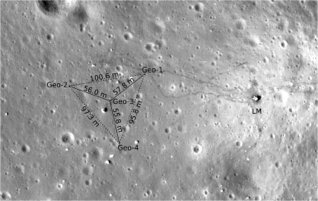 A photo of the surface of the moon with triangular array of seismometers superimposed on top