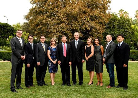 Scientists in formal wear stand for a photo