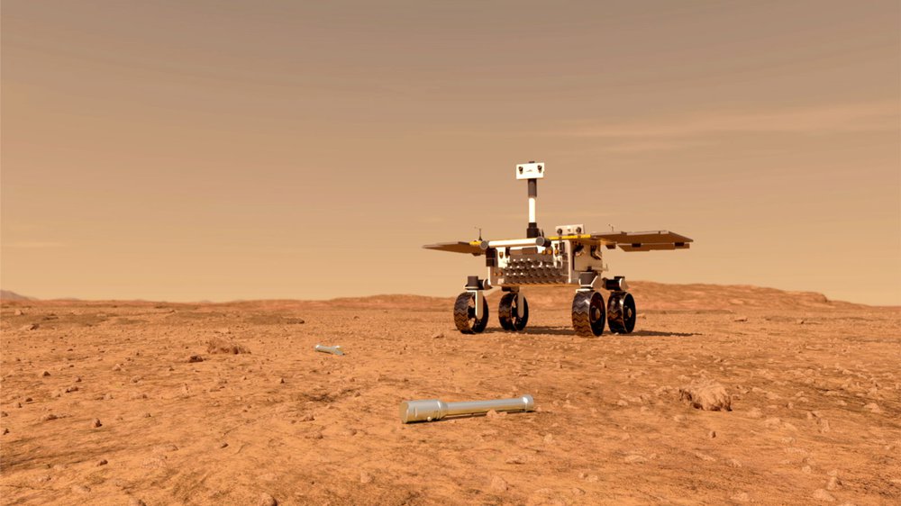 An artist&#x27;s rendering of a small rover approaching silver metal tubes lying on the surface of Mars.